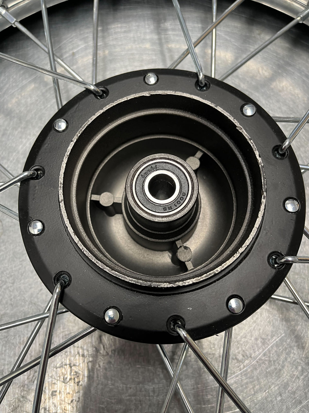 14 (2.50-14) Front Wheel Assembly for Dirt Bikes (Blemished) - Close-up of black metal spokes, rim, and knobby tire. Suitable for 50cc, 70cc, and 90cc Chinese dirt bikes.