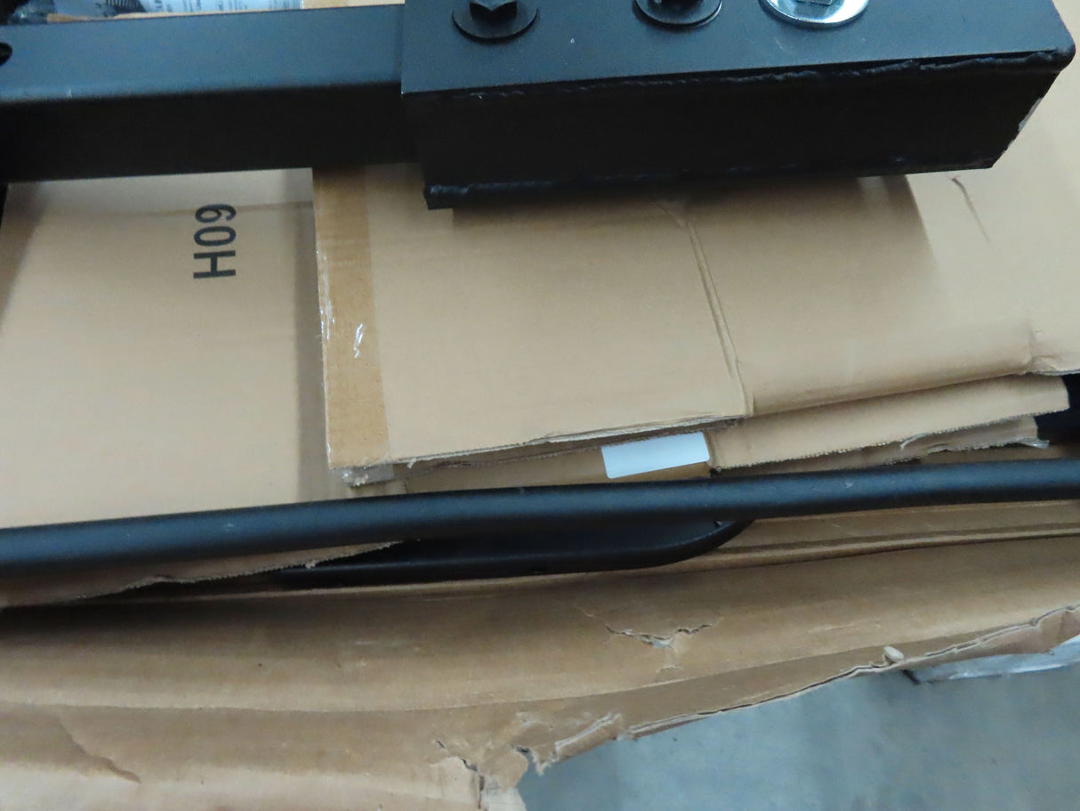 Folding Mighty Lite Aluminum Scooter and Power Chair Carrier (Blemished) on cardboard boxes, showcasing its black metal structure with a visible screw on top.