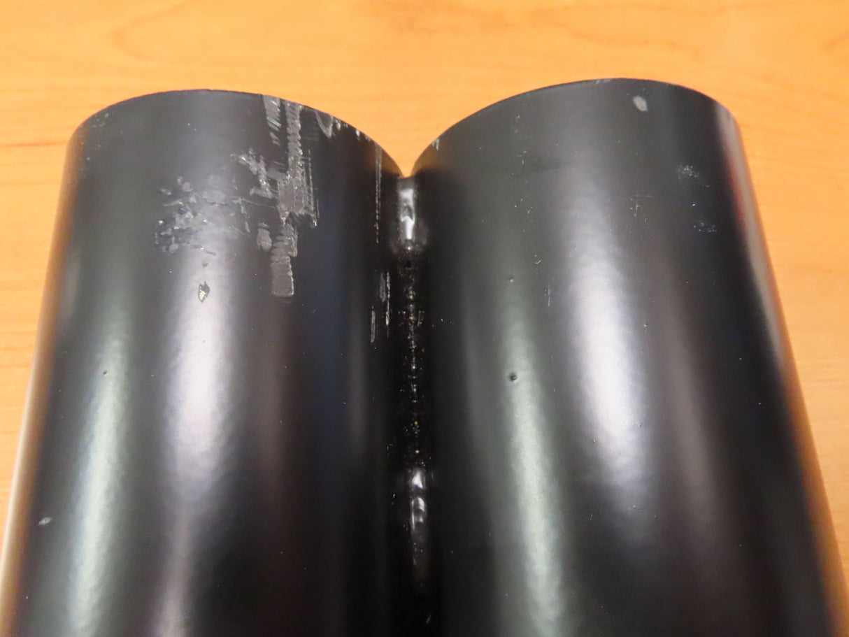 Crutch Holder for Pride Mobility Scooters (Blemished), featuring a black tube with a crack in the corner, resting on a wood surface. Suitable for 3 diameters, available with one or two tubes.
