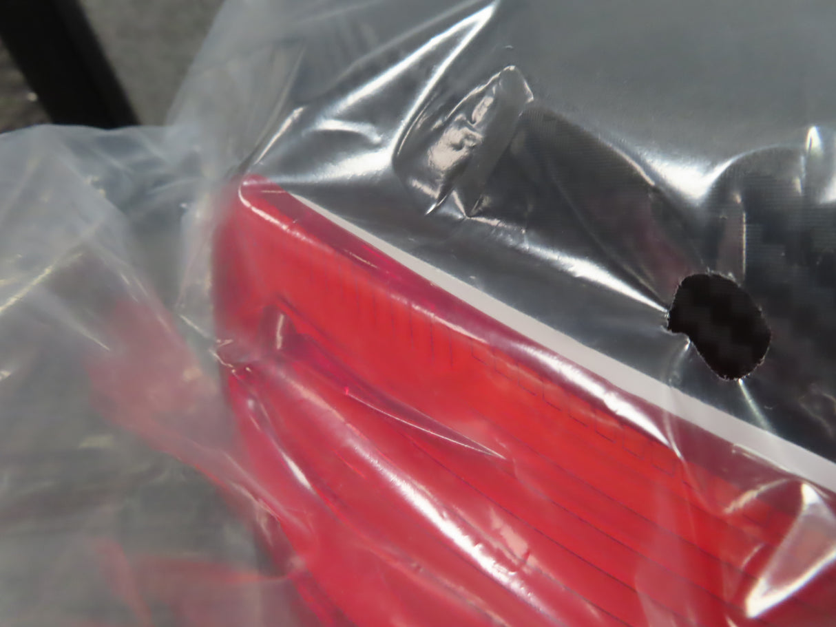 Deluxe Top Case Scooter Trunk (X-Large) (Blemished) with a visible hole in the plastic bag, showcasing its large capacity and universal mounting platform.