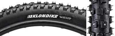 Close-up of the 29x2.1 Klondike Wide Sport Bicycle Tire showcasing its tread pattern and tungsten carbide tipped studs designed for enhanced traction on icy and snowy surfaces.