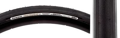 Close-up of the 700x32 Black/Black Gravel King+ Slick Bicycle Tire, highlighting its minimal file tread and robust volume designed for both road and gravel, featuring superior grip and puncture protection.
