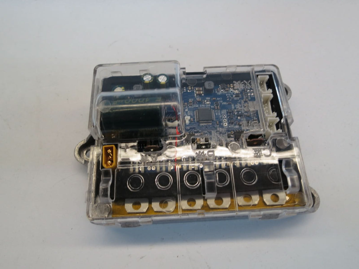 Bluetooth Board, Motherboard, & Harness for Xiaomi Mi M365, shown inside a transparent plastic box with visible circuit board and wiring, crucial for the scooter's console and battery tray operations.