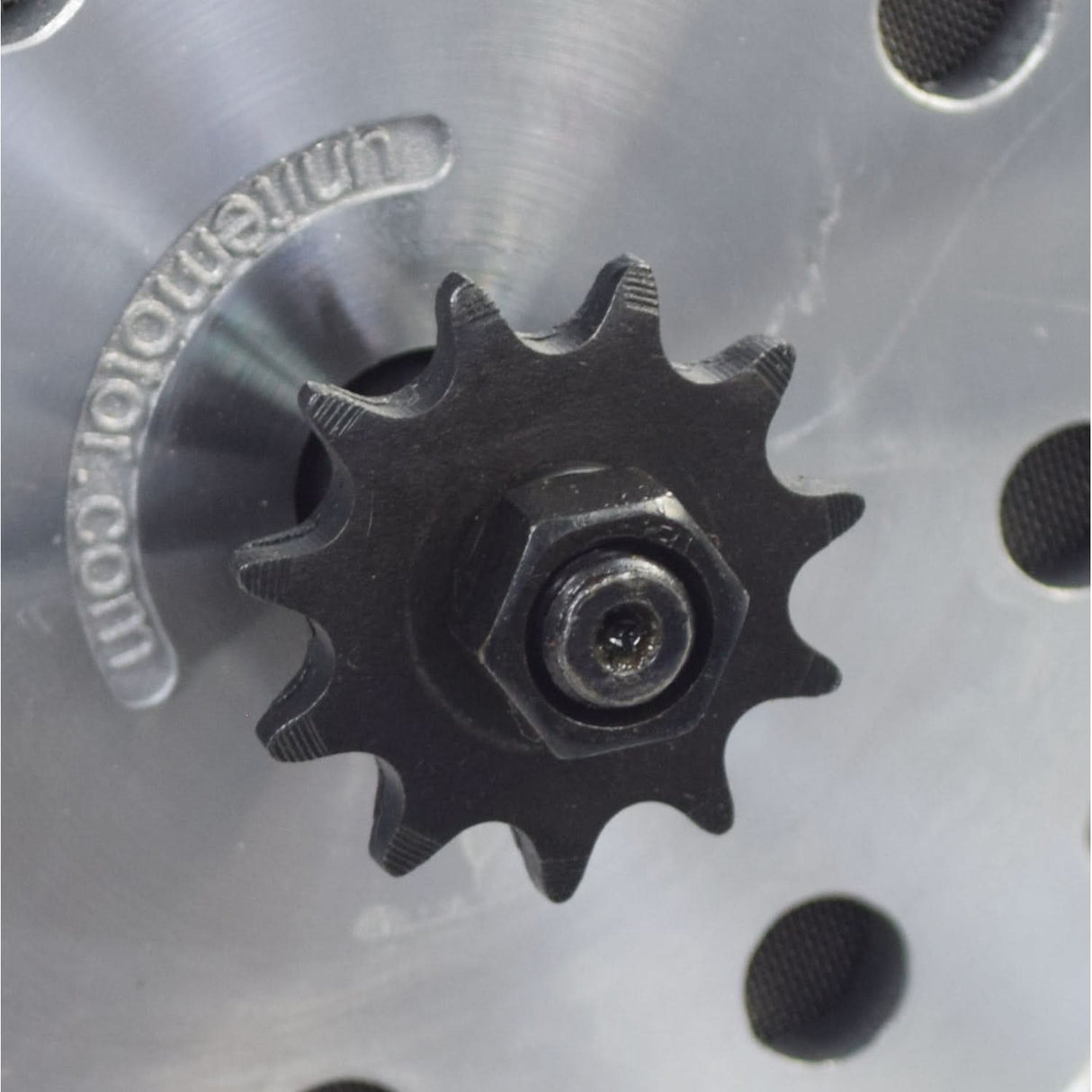 24 Volt 500 Watt MY1020 Electric Motor with 11 Tooth #25 Chain Sprocket (Blemished), showing a black gear on a metal surface, including visible mounting holes and a nut.