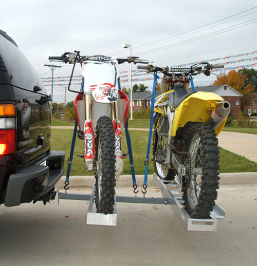 Double Aluminum Dirt Bike & Scooter Carrier securely holding a yellow dirt bike and motorcycle on a trailer, showcasing its robust construction and capacity to transport two bikes with ease.
