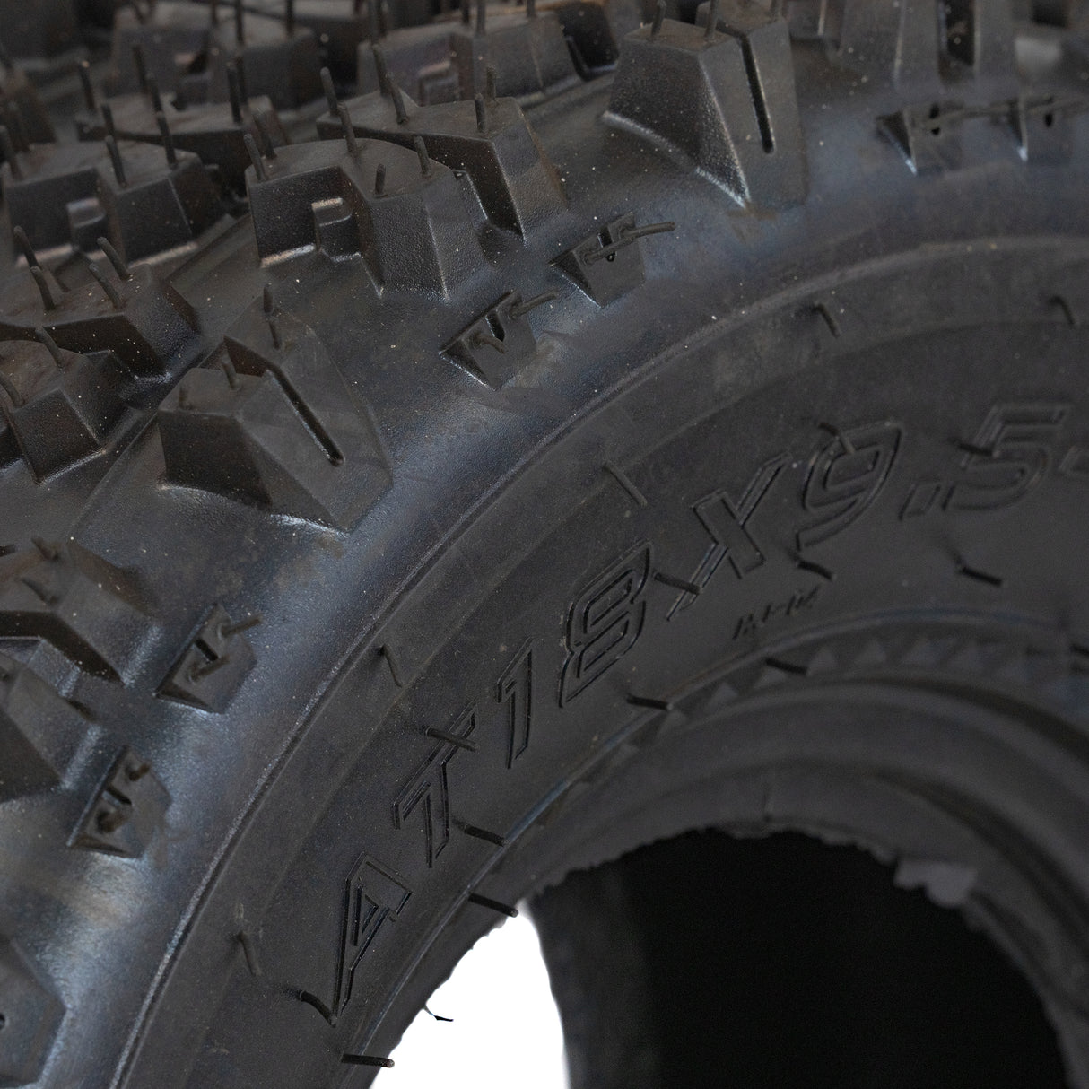 18x9.5-8 Rear Tire for Coleman AT125-EX & AT125-UT ATVs, featuring a knobby tread pattern, close-up view highlighting the durable, tubeless design ideal for all-terrain performance.