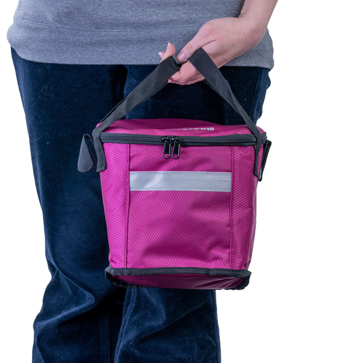 Person holding the Insulated Front Basket Bag for Mobility Scooters, showcasing its sturdy construction and zippered main compartment. The bag is designed to fit various mobility scooter brands.
