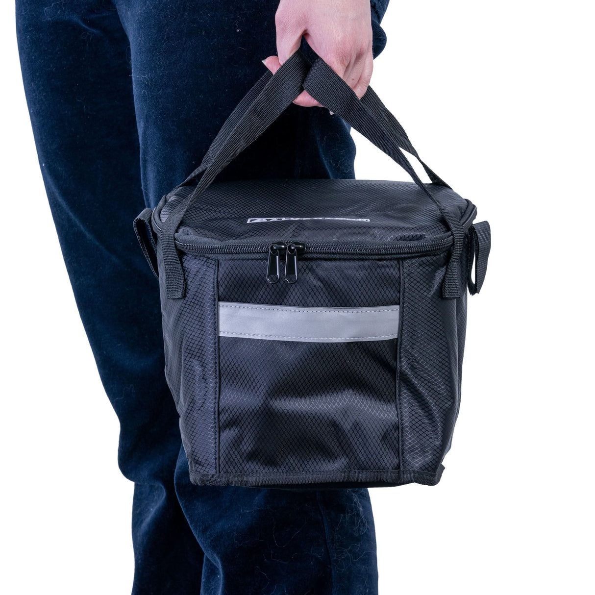 A person holding the Insulated Front Basket Bag for Mobility Scooters, showcasing its sturdy ripstop polyester material, zippered main compartment, and leather label.