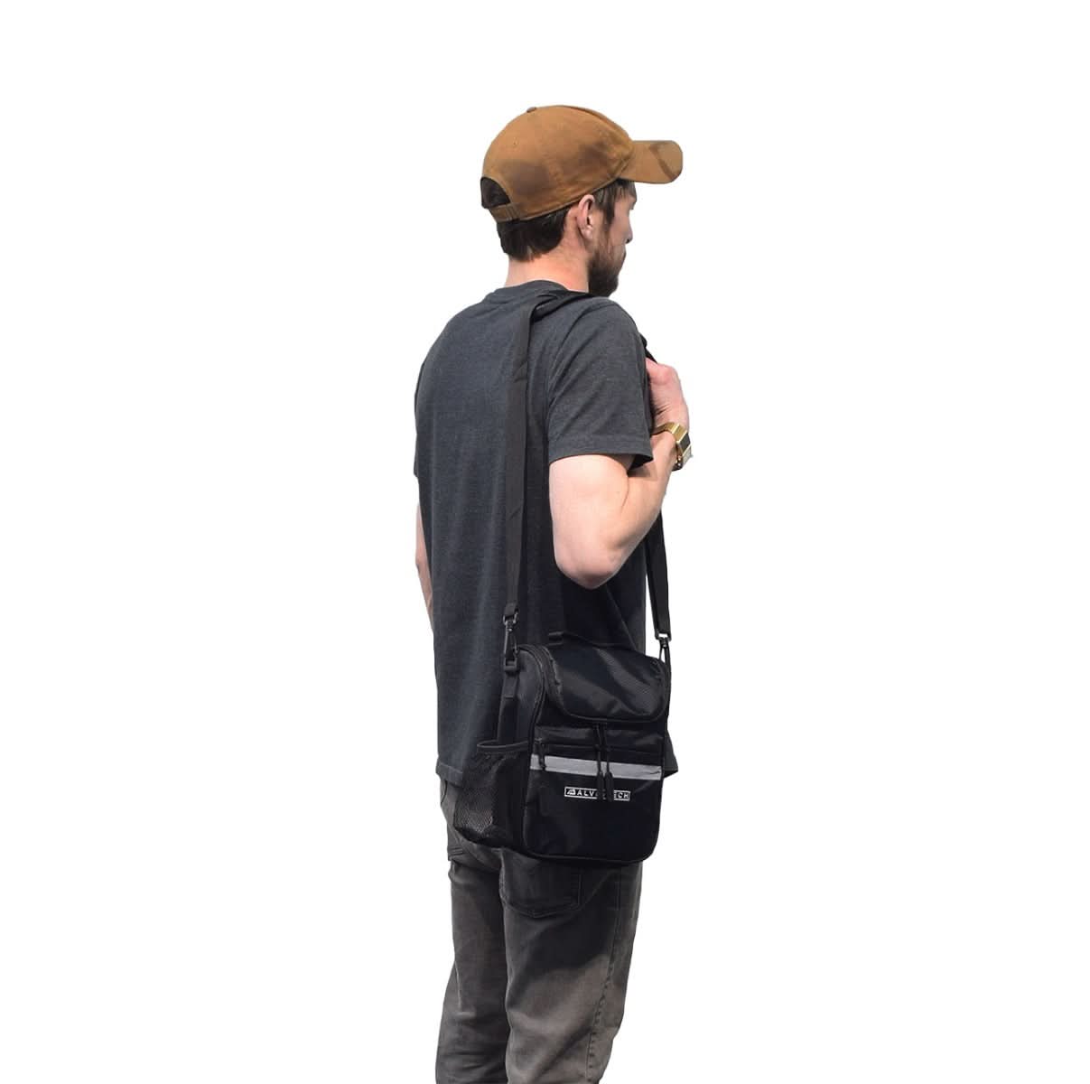 Man carrying an Insulated Handlebar Bag with Rain Cover & Carrying Strap for Bikes & Scooters, wearing a hat, showcasing the bag's practical design and usability for cyclists and scooterists.