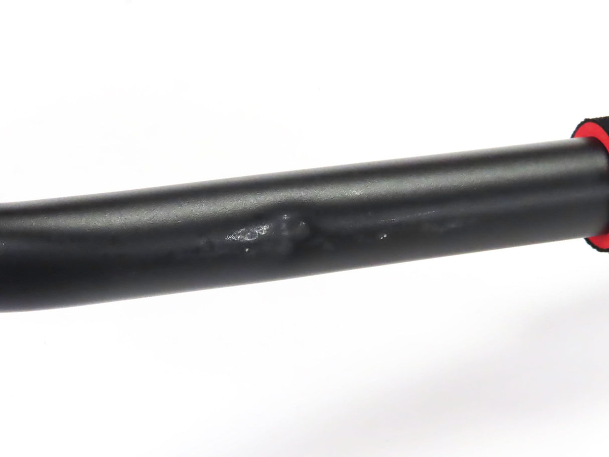 Close-up of the Deluxe Hoverboard Go-Kart Attachment Kit with Large Front Wheel & Suspension (Blemished), showcasing the black pipe and visible scratches on the black enamel finish and plastic seat.