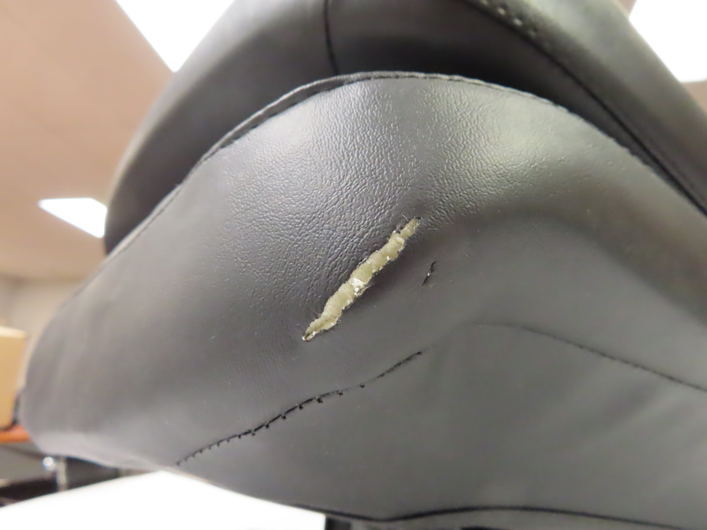 17 Wide Molded Seat Assembly for Go-Go and Pride Mobility Scooters (Blemished), showing a black leather seat with a 1 tear on the front of the seat base upholstery.