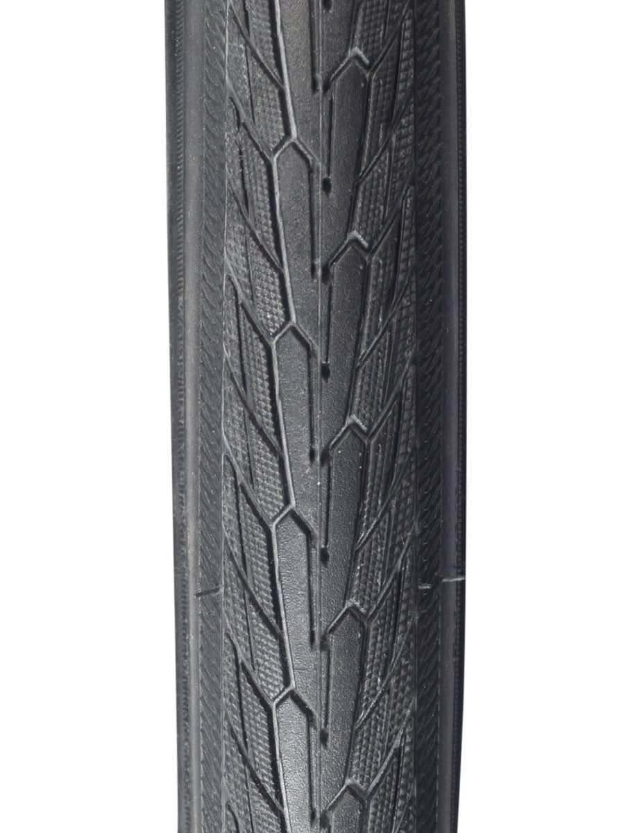 Close-up of a 700x32 Reflective Road Cruiser Active Twin K-Guard Bicycle Tire, highlighting the directional tread pattern with micro-knurled shoulders and reflective sidewall striping for enhanced visibility.