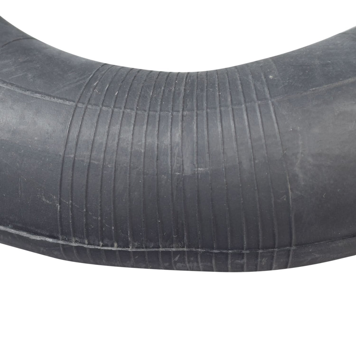 8-1/2x2 Kick Scooter Tire with P1034 Tread, featuring a black rubber tube with a curved edge, close-up of directional tread pattern, ideal for Trikke carving and recreational scooters.