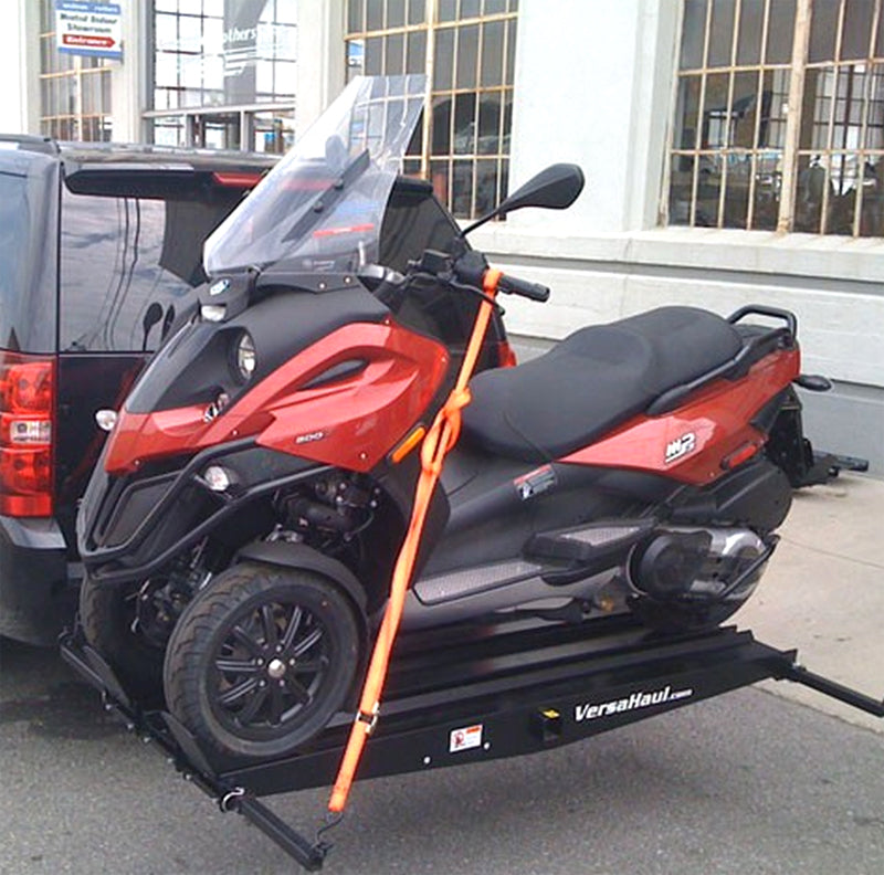 Scooter Carrier for the Piaggio MP3 on a trailer, showcasing its secure tie-down straps, robust design, and three ramps for easy loading. Ideal for transporting 3-wheel scooters.