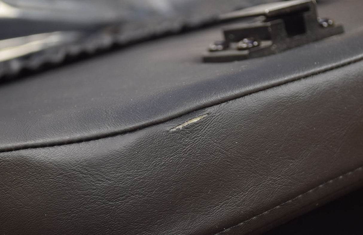 Close up of the 18x18 High Back Black Vinyl Limited Recline Seat Assembly for the Jazzy 1100, showcasing the black leather texture and stitching details.
