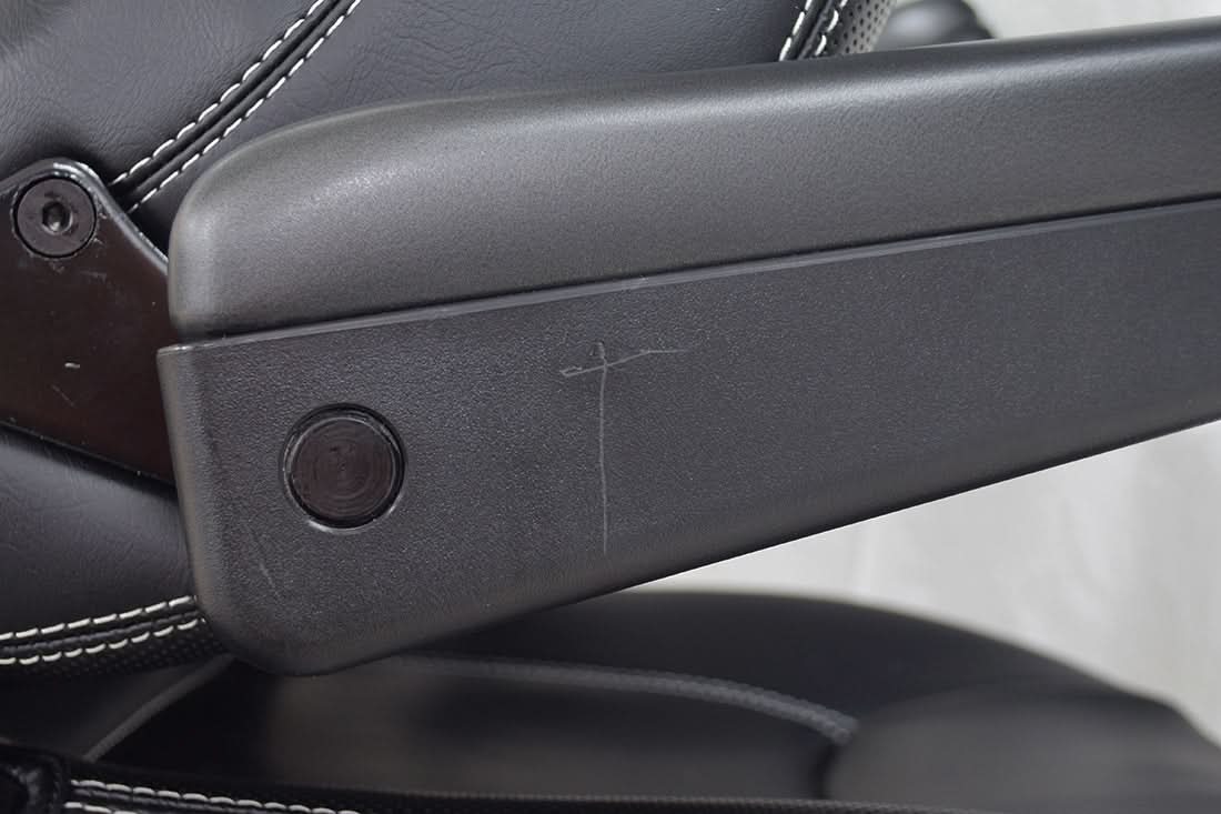 Close-up of the 20 Seat for the Pride Mobility Sport Rider Scooter (Blemished), highlighting the black armrest, keyhole, and leather surface detailing.
