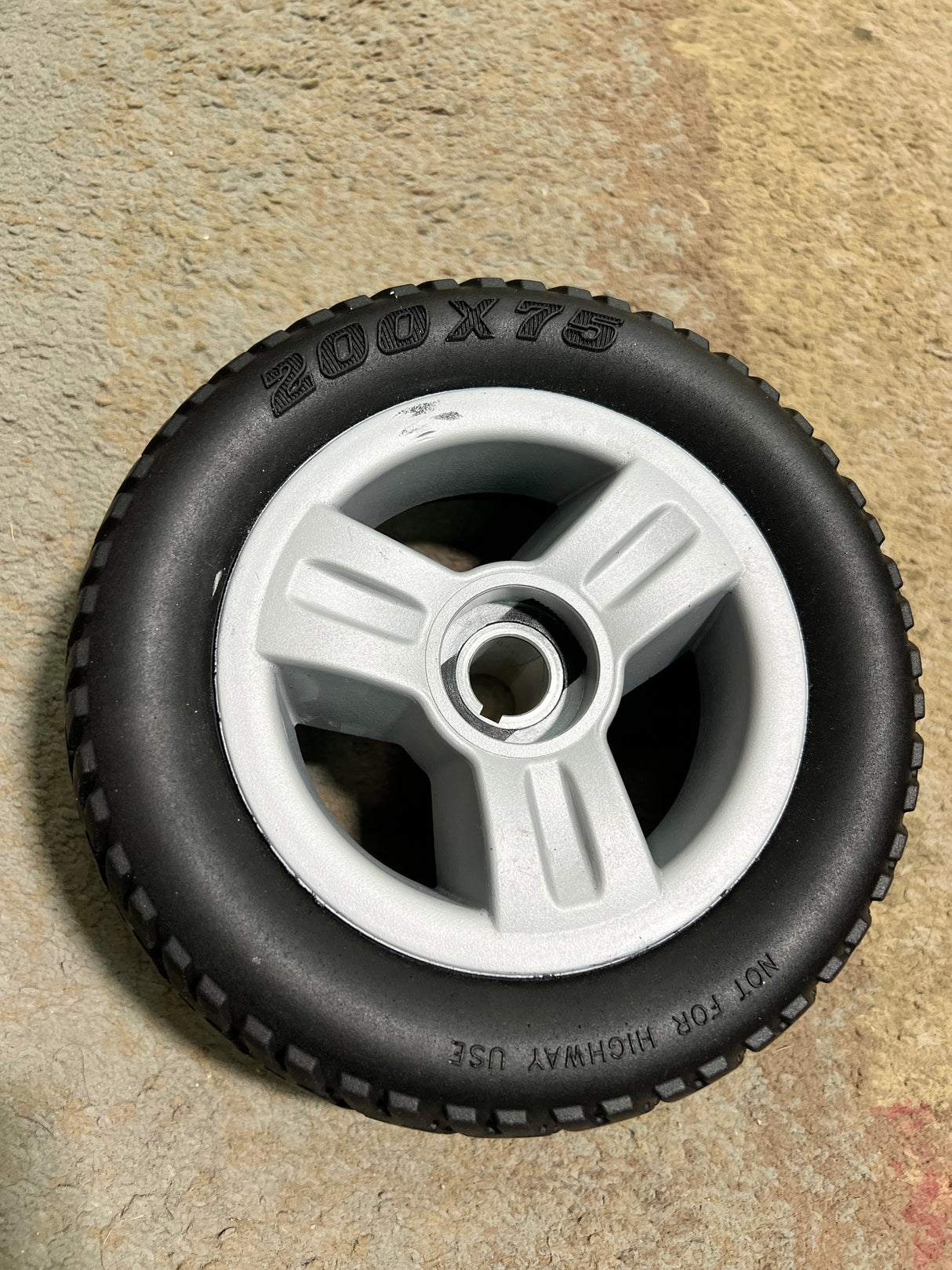 8x2.50 Rear Wheel Assembly for the Go-Go Elite Traveller (SC40E/SC44E) featuring a black and silver tire with a sturdy silver rim, designed for performance and dependability.