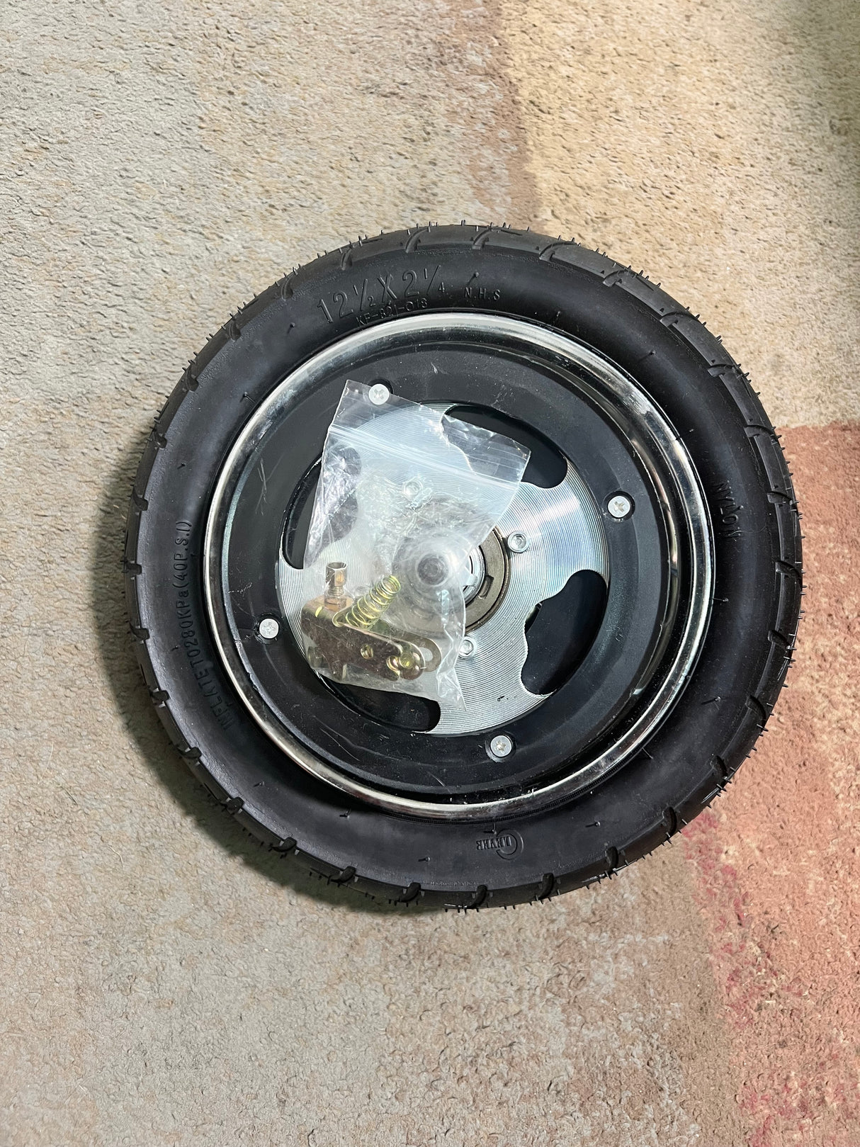 Rear Wheel Assembly with Wire Spoke Rim for the Razor Pocket Mod (Versions 13-30) (Blemished) featuring a black tire, wire spokes, and included tube and rim.