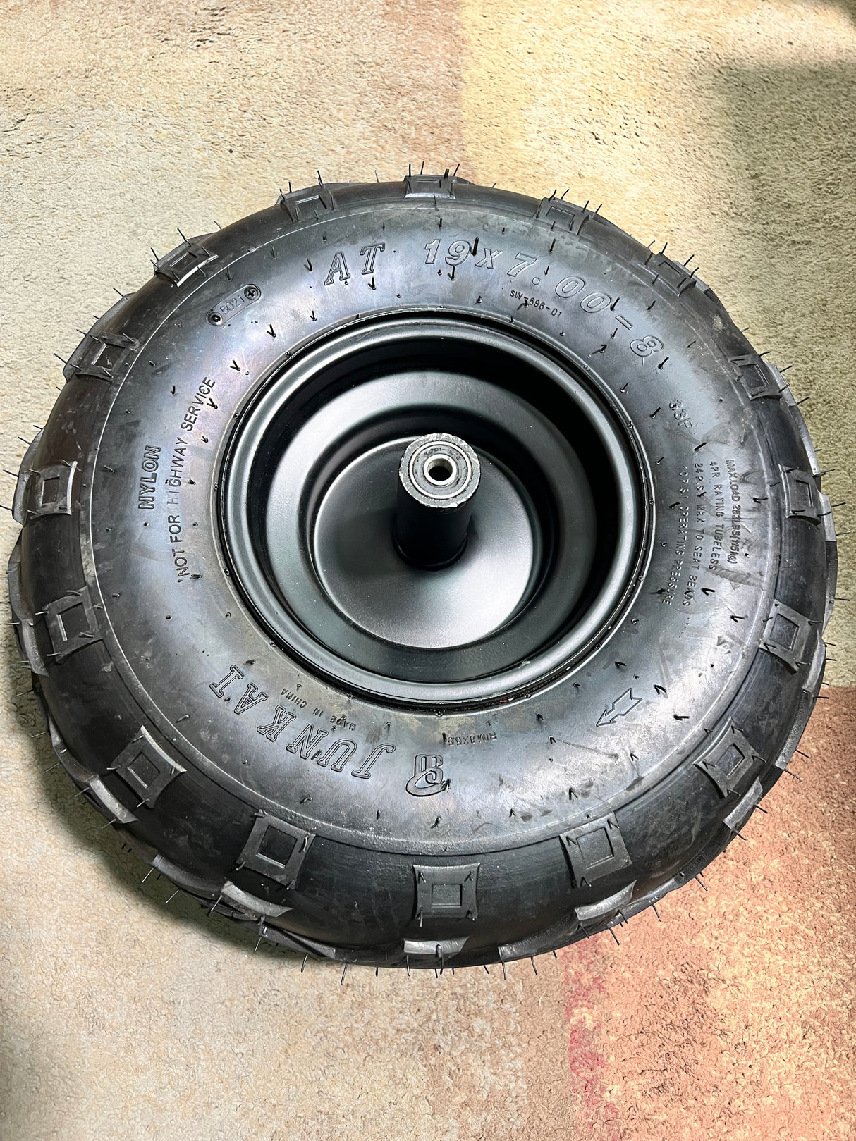 Front Wheel Assembly with Tire for the Coleman RB200 212cc Mini Bike (Blemished) shows a black tire with V-tread on a metal wheel, complete with bearings and Schrader valve.