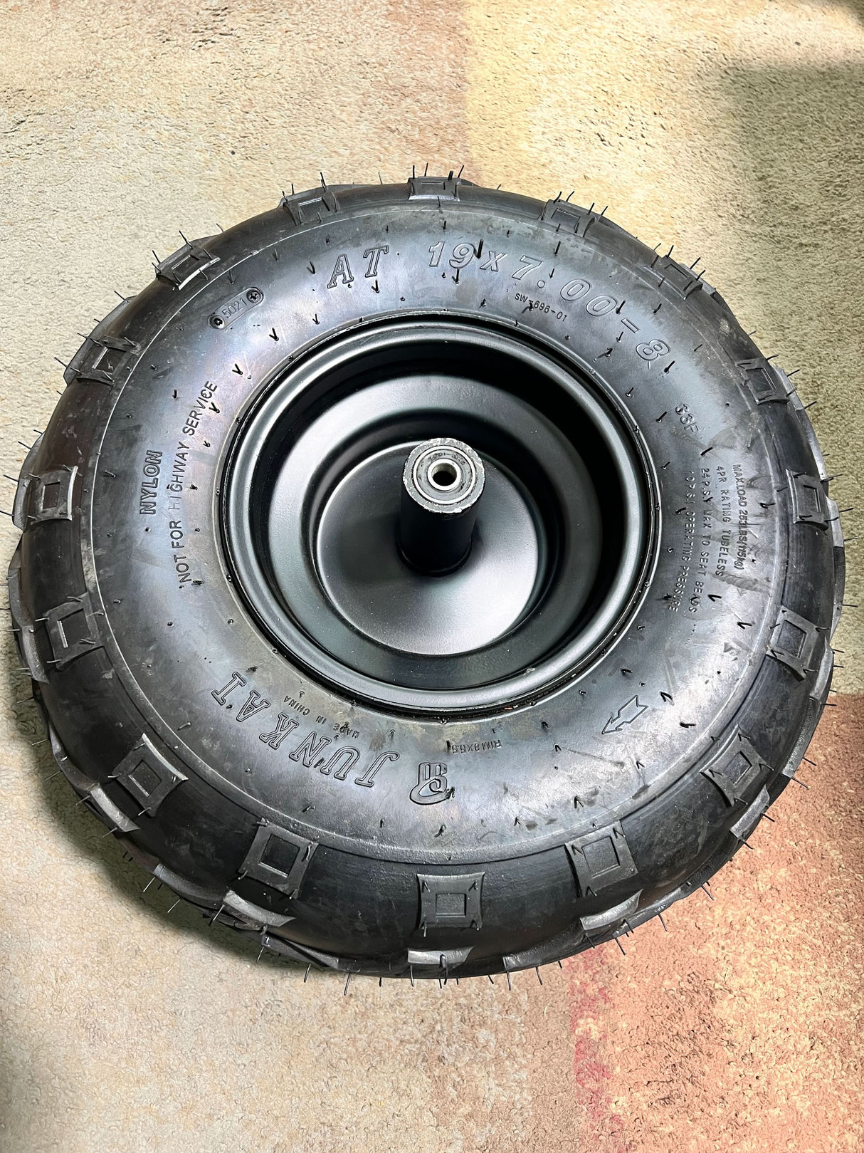 Front Wheel Assembly with Tire for the Coleman RB200 212cc Mini Bike (Blemished) shows a black tire with V-tread on a metal wheel, complete with bearings and Schrader valve.