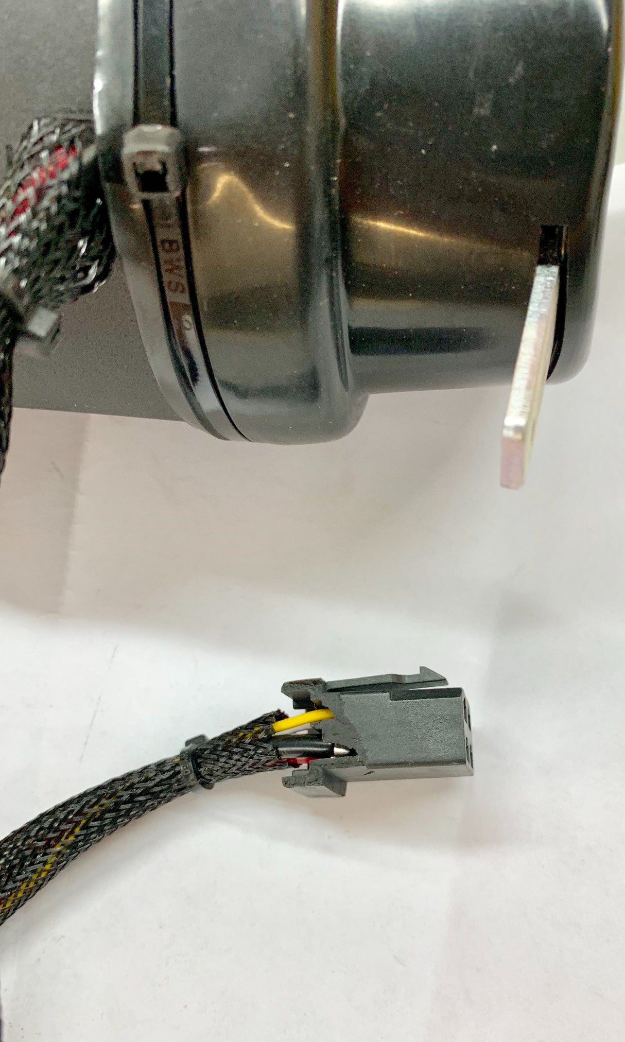 Close-up of the Left Drive Motor Assembly for the Jazzy Select & Select GT (Blemished), featuring a black device with attached wires and connectors, including the mounting brackets and shaft key.