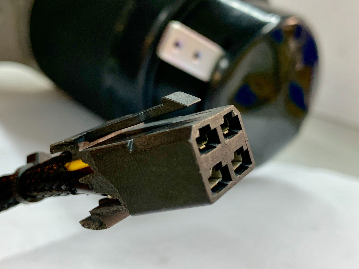 Close-up of the Left Drive Motor Assembly for the Jazzy Select & Select GT, featuring the motor with mounting brackets, shaft key, bolts, and washers, highlighting the intricate components and connections.