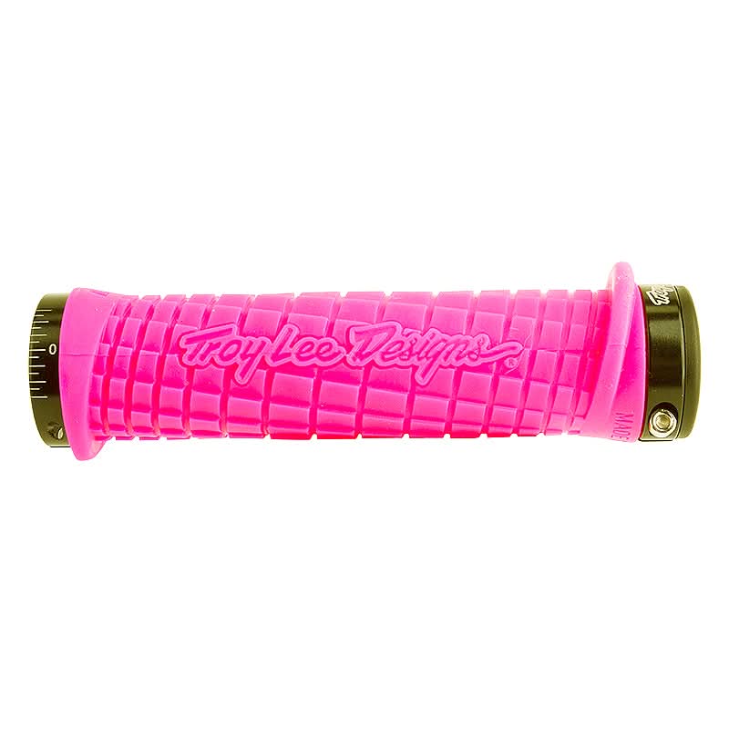Pink Troy Lee Lock-on Handlebar Grips for Bikes & Scooters with black caps, featuring grooved channels and overmolded flap for added protection, and custom flanged design providing 143 mm of gripping surface.