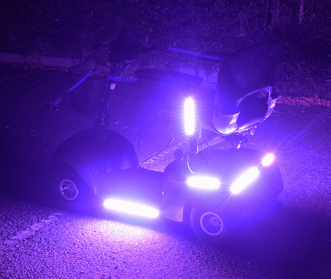 Multi-Color LED Light Kit for Pride Mobility Scooters, featuring a scooter with illuminated light strips, showcasing vibrant lighting effects controlled via remote for a customizable, eye-catching ride.