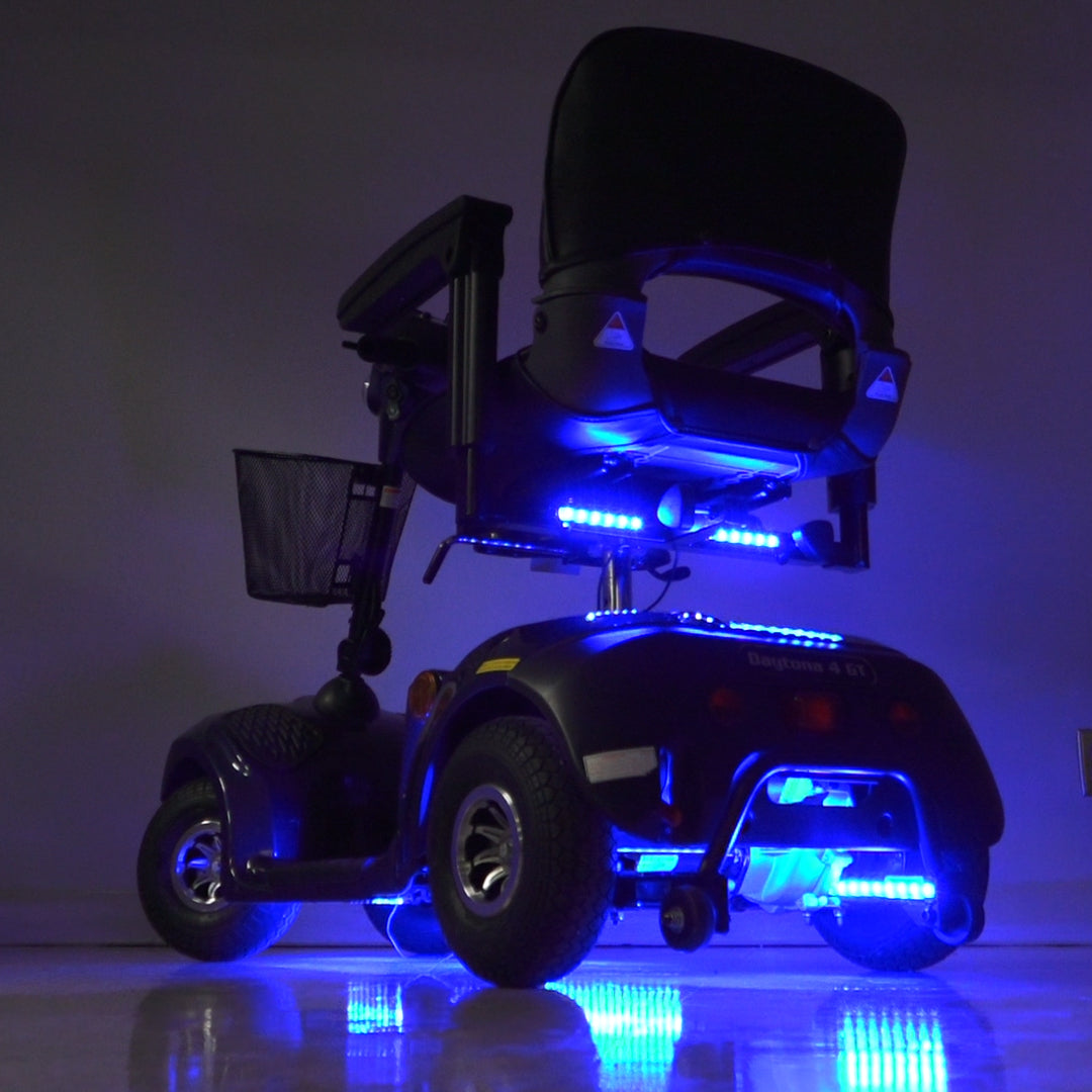 Multi-Color LED Light Kit for Mobility Scooters & Power Chairs, featuring a motorized wheelchair adorned with blue LED lights, showcasing adjustable light strips for a customizable, vibrant glow.