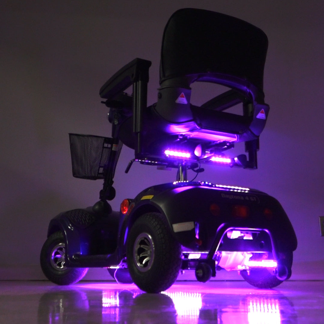 Multi-Color LED Light Kit for Mobility Scooters & Power Chairs, featuring vibrant purple lights, a black electric scooter, and close-ups of illuminated tires, offering customizable, weather-resistant lighting for a unique mobility experience.