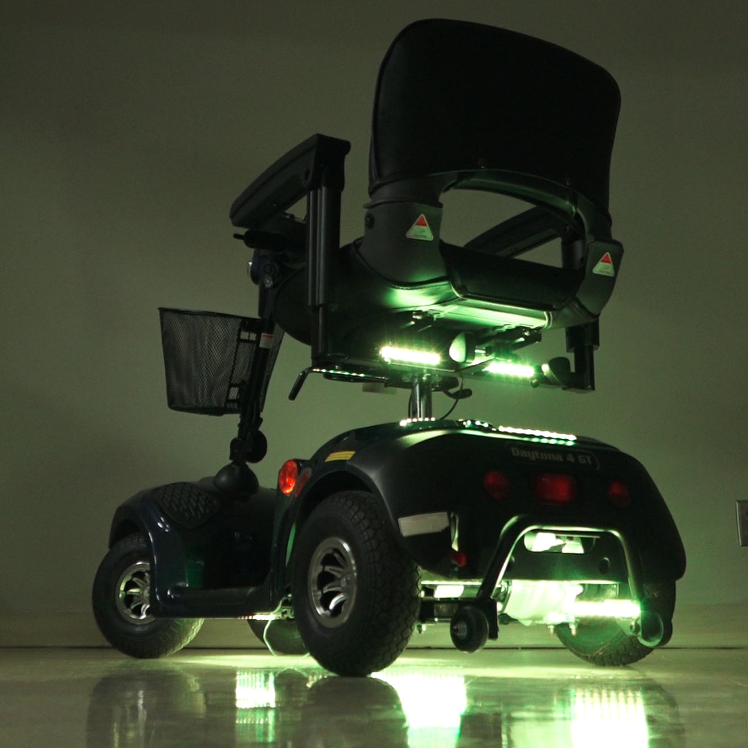 Multi-Color LED Light Kit for Mobility Scooters & Power Chairs, showcasing a scooter with illuminated LED strips, a close-up of a tire, and a black mesh basket, enhancing visibility and style.