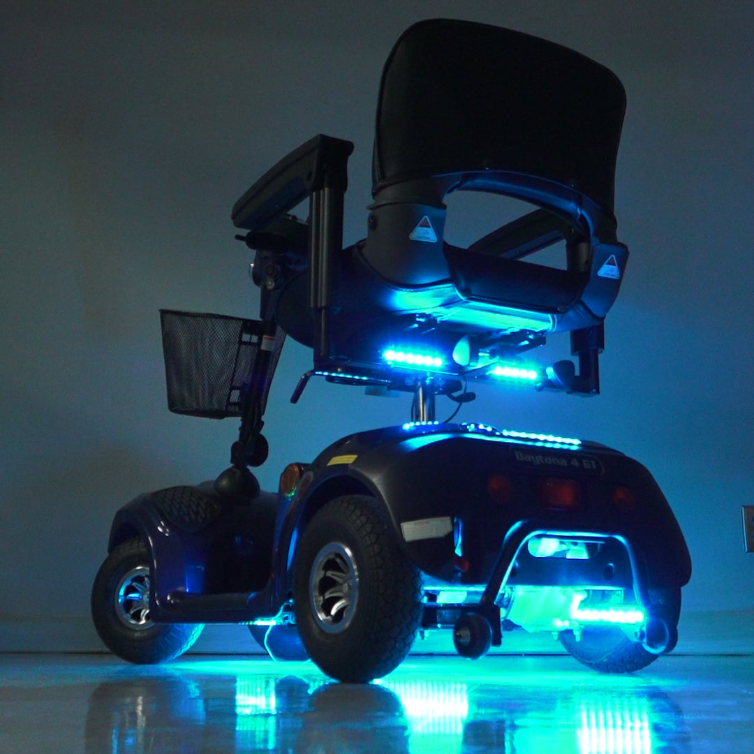 Multi-Color LED Light Kit for Mobility Scooters & Power Chairs, featuring blue-lit strips on a scooter, highlighting a close-up of the wheel with integrated lights for a vibrant, customizable ride.