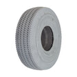 Close-up of the 4.10/3.50-4 Foam-Filled Mobility Tire with C189 Sawtooth Tread, showcasing its detailed synthetic rubber texture and central hole, designed for mobility scooters and power wheelchairs.