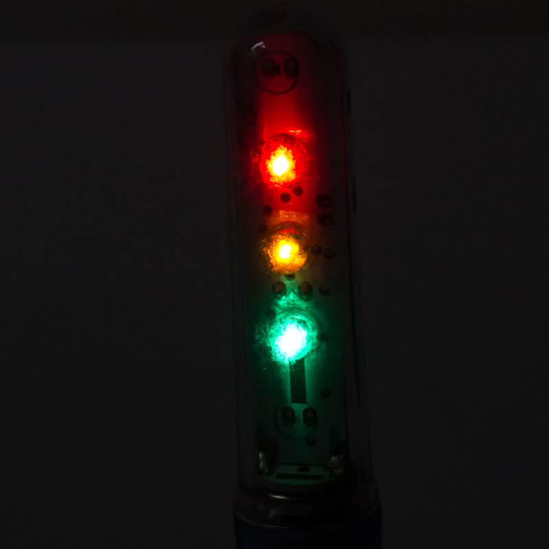 Close-up of the Valve Stem Wheel Flash Saber in Red/Yellow/Green, highlighting its light feature designed for bikes and scooters.