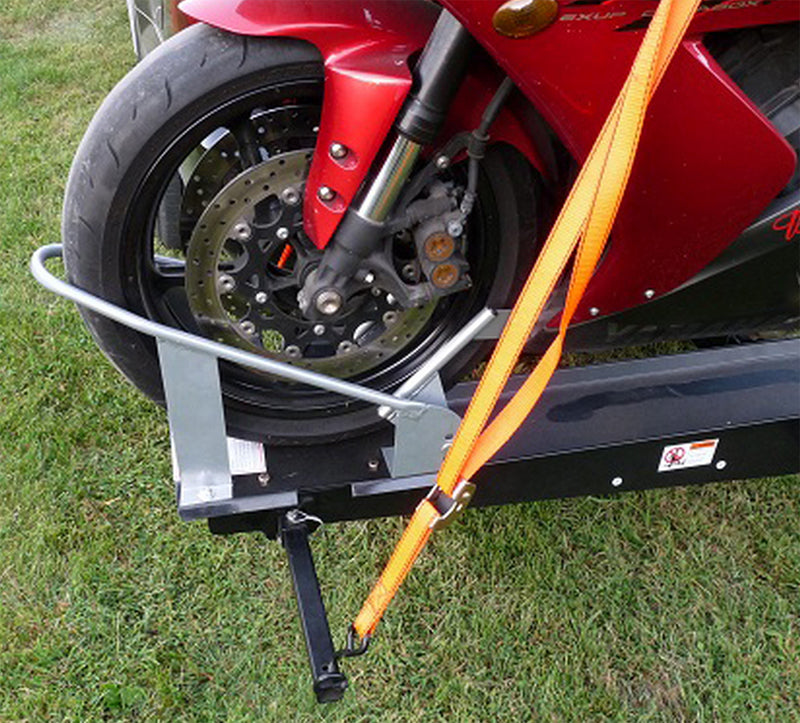 Wheel Chock for Sport Bike Carriers mounted on a trailer, securing the motorcycle's front wheel with a sturdy frame to prevent rolling or shifting.