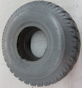 3.00-4 (10x3, 260X85) Foam-Filled Mobility Tire (2-5/8 Bead Width) with Durotrap C9210 Tread (Blemished), shown on a tile floor, featuring a central hole and non-marking gray surface.