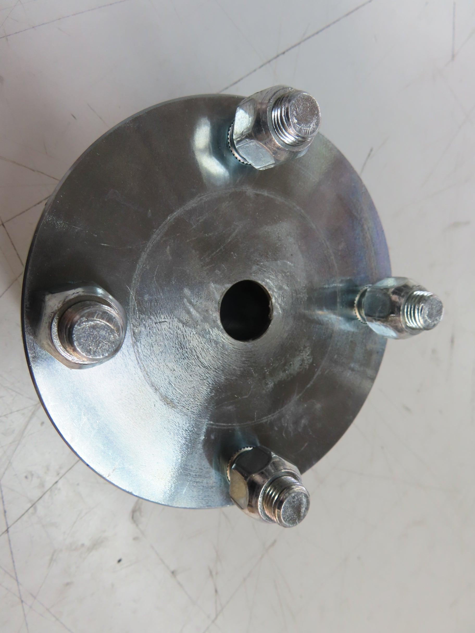 4 x 4 Go-Kart Live Axle Hub with 1 to 3/4 Step-Down (Blemished) featuring visible bolts, nuts, and screws in a close-up view.