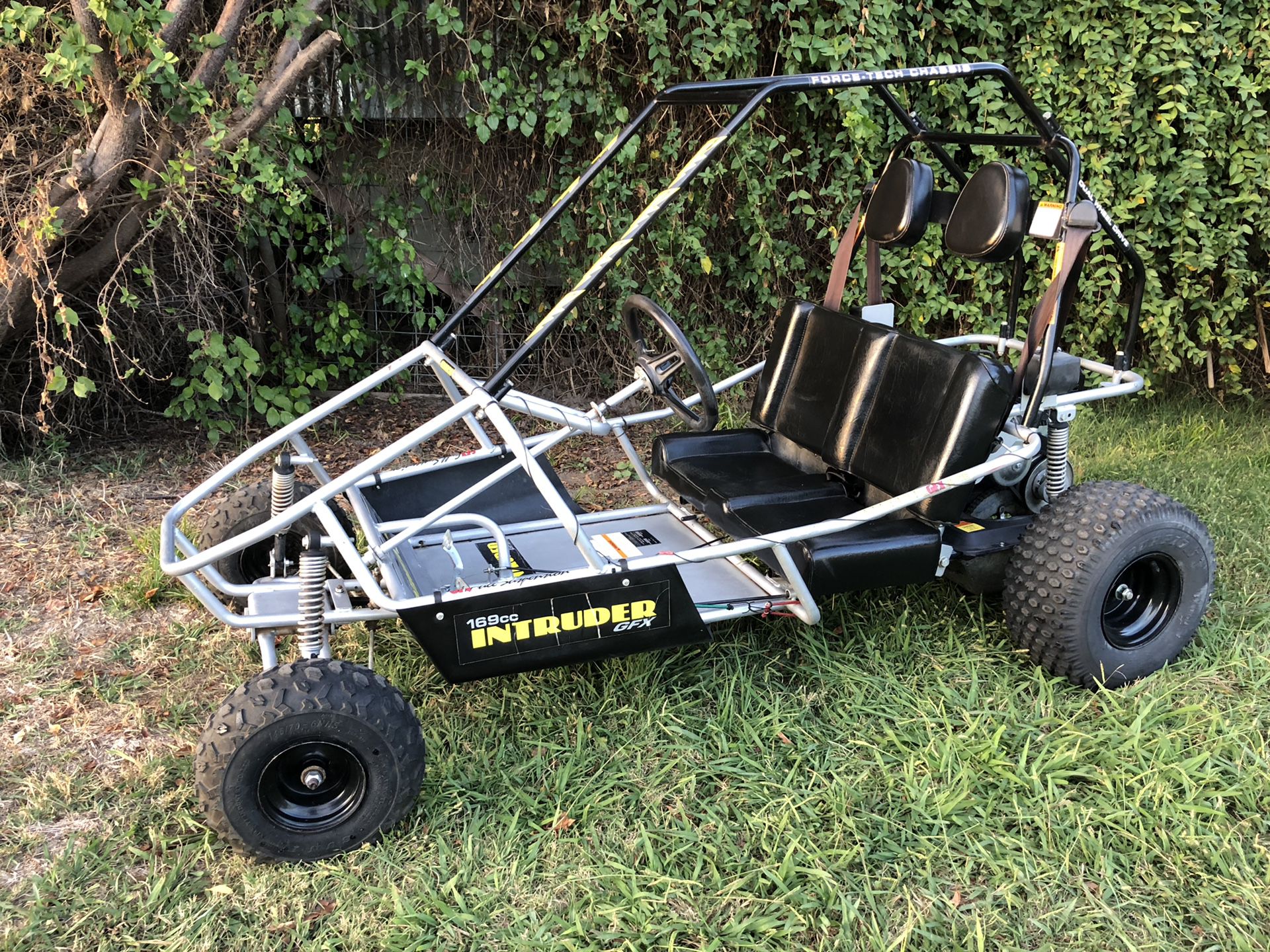 Recoil Pull Start for Predator 79cc, 212cc, & 301cc Engines; black and silver unit with cord, handle, pawl, and slotted metal guard, displayed on a go-kart chassis with visible tires and seats.