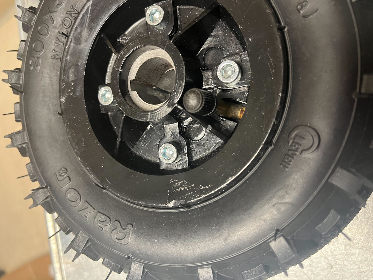 Razor Dune Buggy Rear Wheels (Set of 2) (Missing Hardware) featuring a black tire with a screw embedded in the center, highlighting the need for replacement or repair.