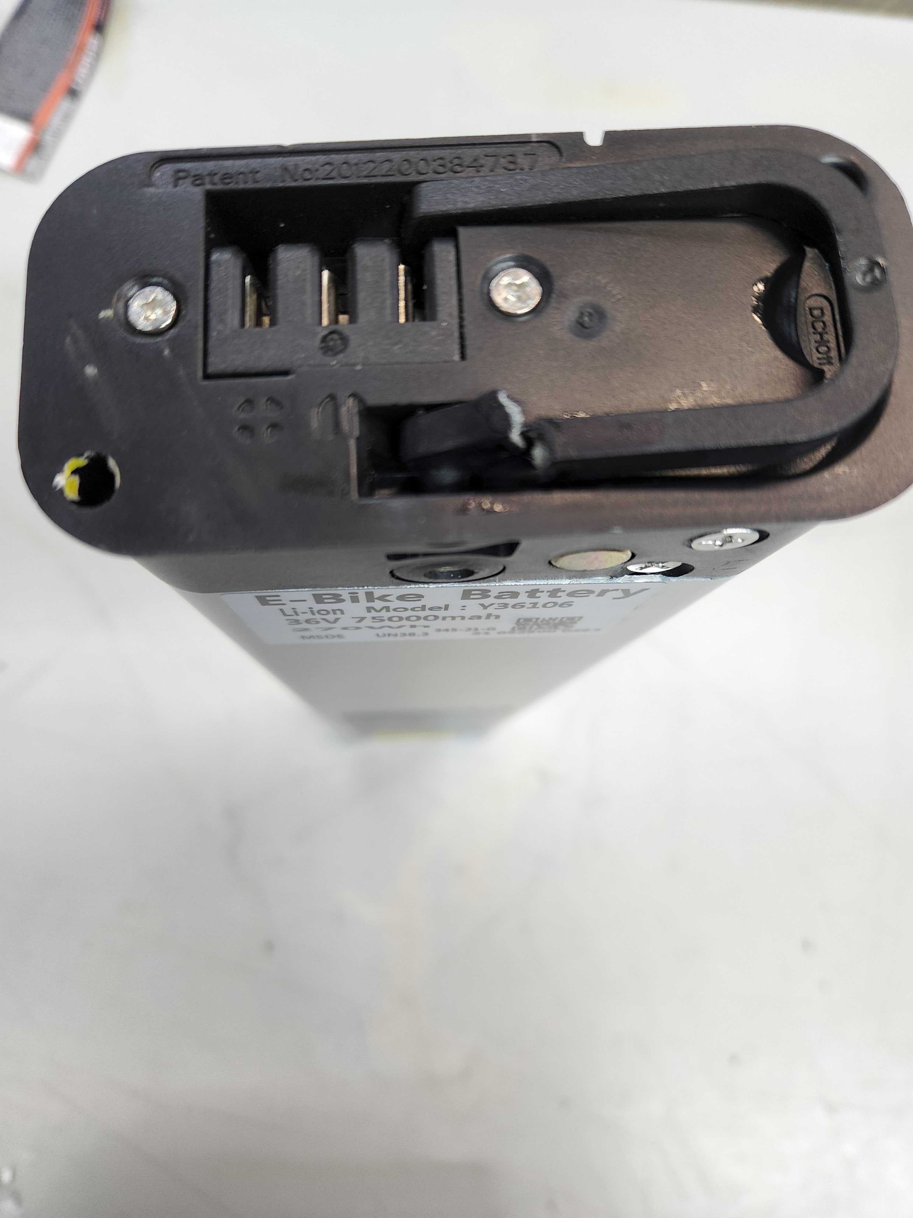 Close-up of the 36 Volt Battery Pack for the GOTRAX EBE1 Folding Super Sport Bike 16 (Blemished), showcasing its compact design, coaxial charging port, and locking mechanism.