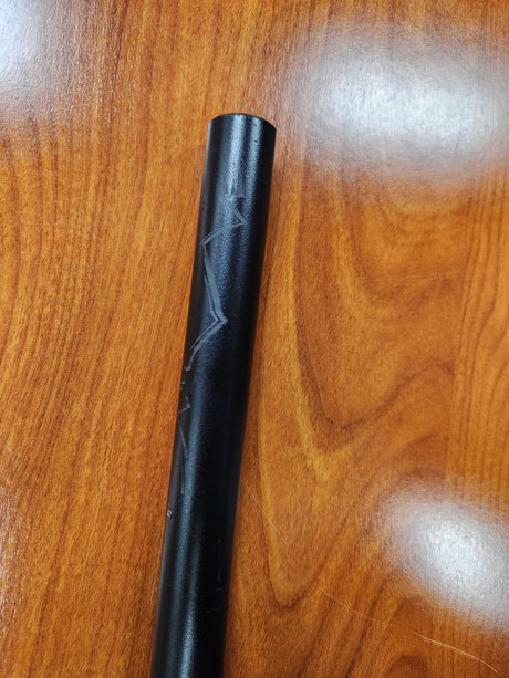 19 Handlebar for the Jetson® Bolt Folding Electric Bicycle (Blemished) shown as a black metal tube with white marks, placed on a wood surface.