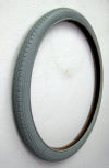 24x1.75 Pneumatic Wheelchair Tire on a white surface, featuring non-marking gray rubber with street tread. Tube sold separately.