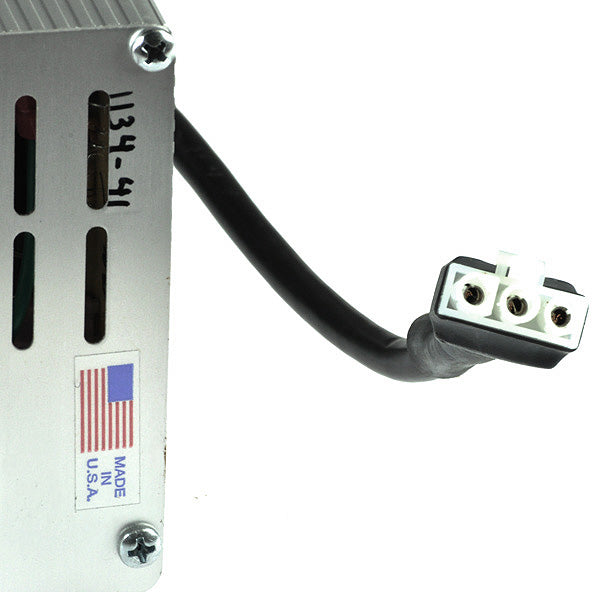 Close-up of the 24 Volt On-Board Battery Charger for the Golden Technologies Companion I and II Mobility Scooters, featuring a white rectangular casing and visible cables.