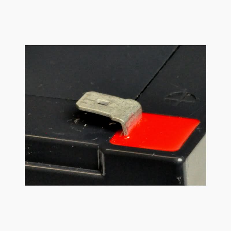 Close-up of the 24 Volt Battery Pack for the Go-Go Go-Chair, highlighting metal connectors on a black box, showcasing robust construction and AGM technology features.