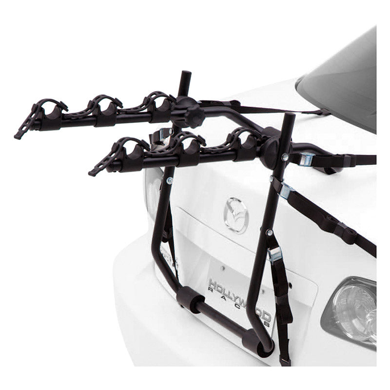 Express Trunk Rack mounted on a car, designed to carry 2 or 3 bikes with protective rubber cradles and adjustable hubs.