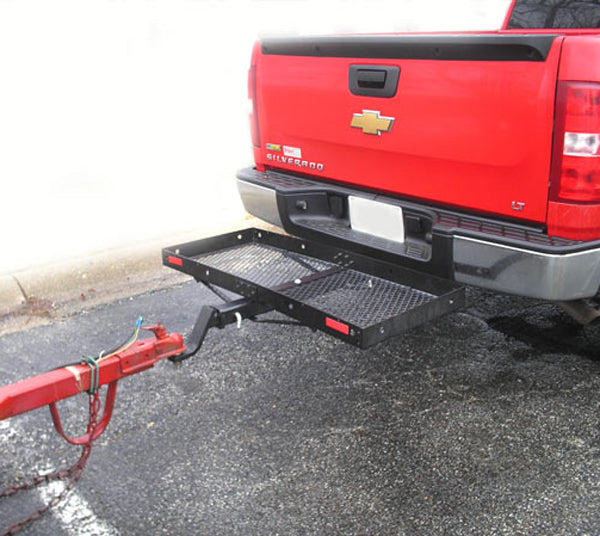 48 x 20 Steel Cargo Carrier with Tow Option attached to the back of a red truck, showcasing its mesh bed and rear Class III receiver hitch for additional towing capabilities.