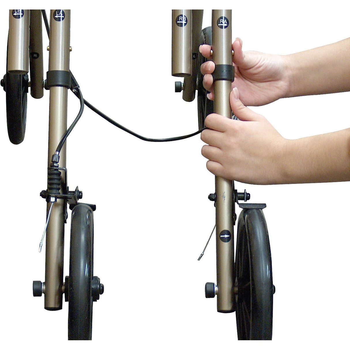 Person using Drive Medical 780 Adult Knee Walker, gripping the handlebar. The knee walker features a stable design with 8 caster wheels and a handbrake, providing enhanced mobility and safety.