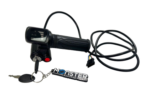 Black scooter throttle with key and 'Monster' keychain on a white surface