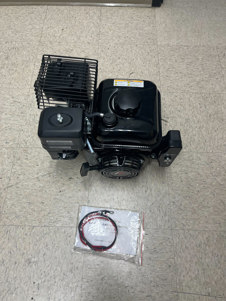 Electric Start 196cc 6.5 Hp 168F Honda GX200 Clone Go-Kart & Mini Bike Engine (Blemished) on a tile floor, showcasing its components including the fuel tank, muffler, and air filter.