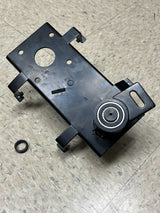 Jackshaft Assembly for Coleman BT200X, CT200U, & CT200U-EX Mini Bikes (Blemished), featuring a black metal frame with a circular hole, a screw, nut, and four mounting leg tabs on a marble surface.